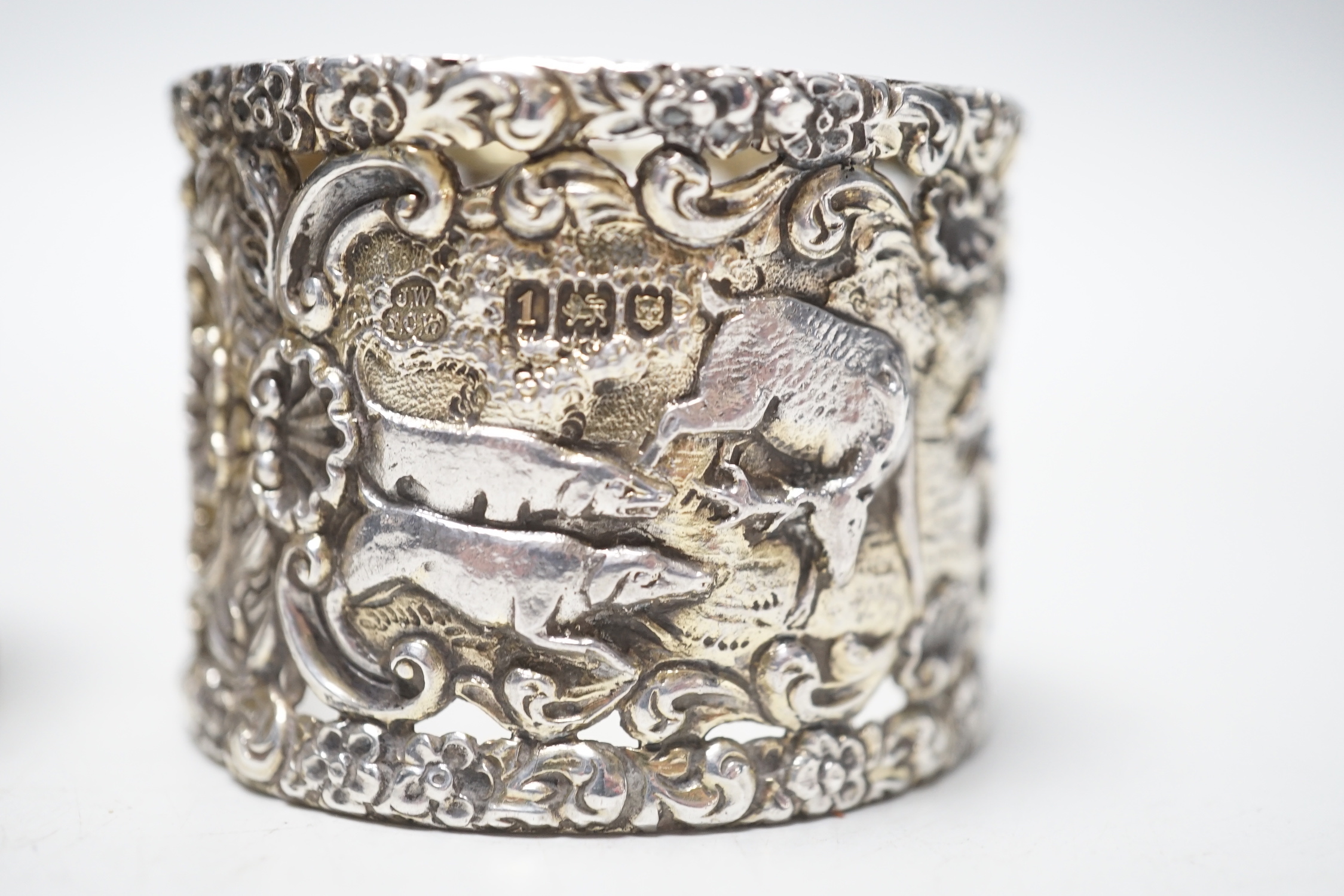 A pair of Edwardian silver serviette rings, pierced and embossed with deer hunting scenes, Wakely & Wheeler, London, 1906, 38mm.